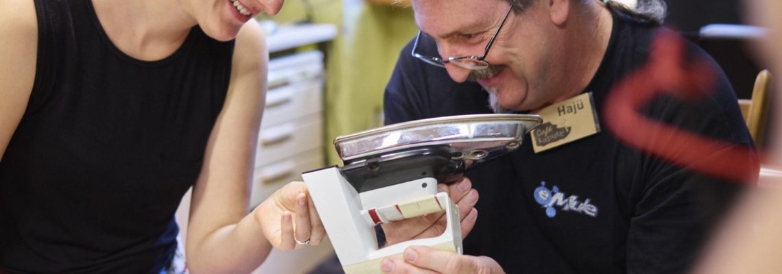 Eine Frau und ein Mann sehen sich zusammen ein Bügeleisen an.