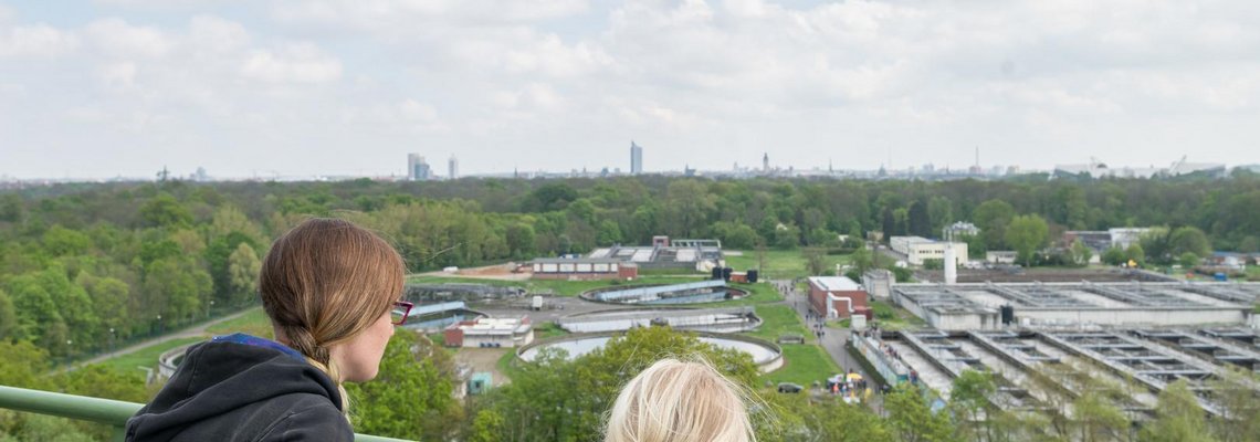Familie blickt von der Aussichtsplattform der Faultürme auf das Gelände des Klärwerks.