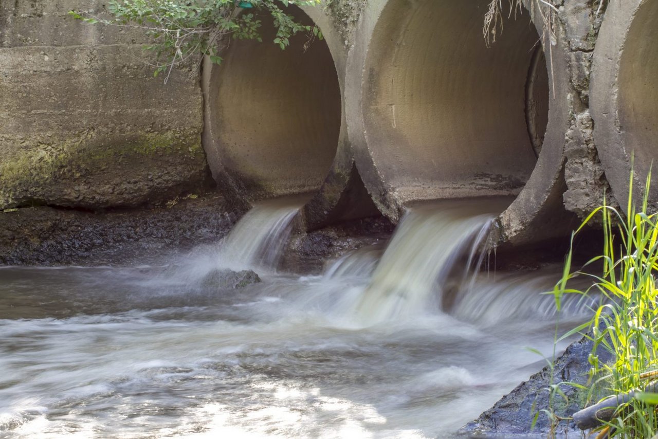 Aus zwei Kanalöffnungen fließt Wasser heraus.